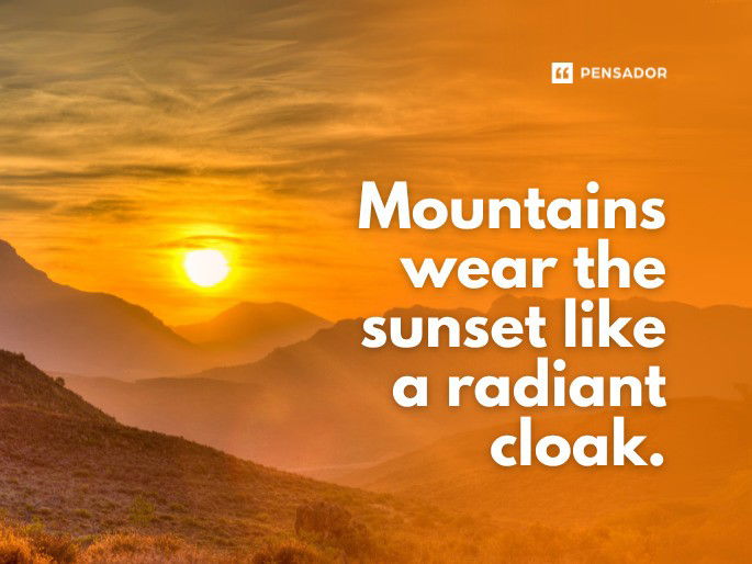 Mountains wear the sunset like a radiant cloak.